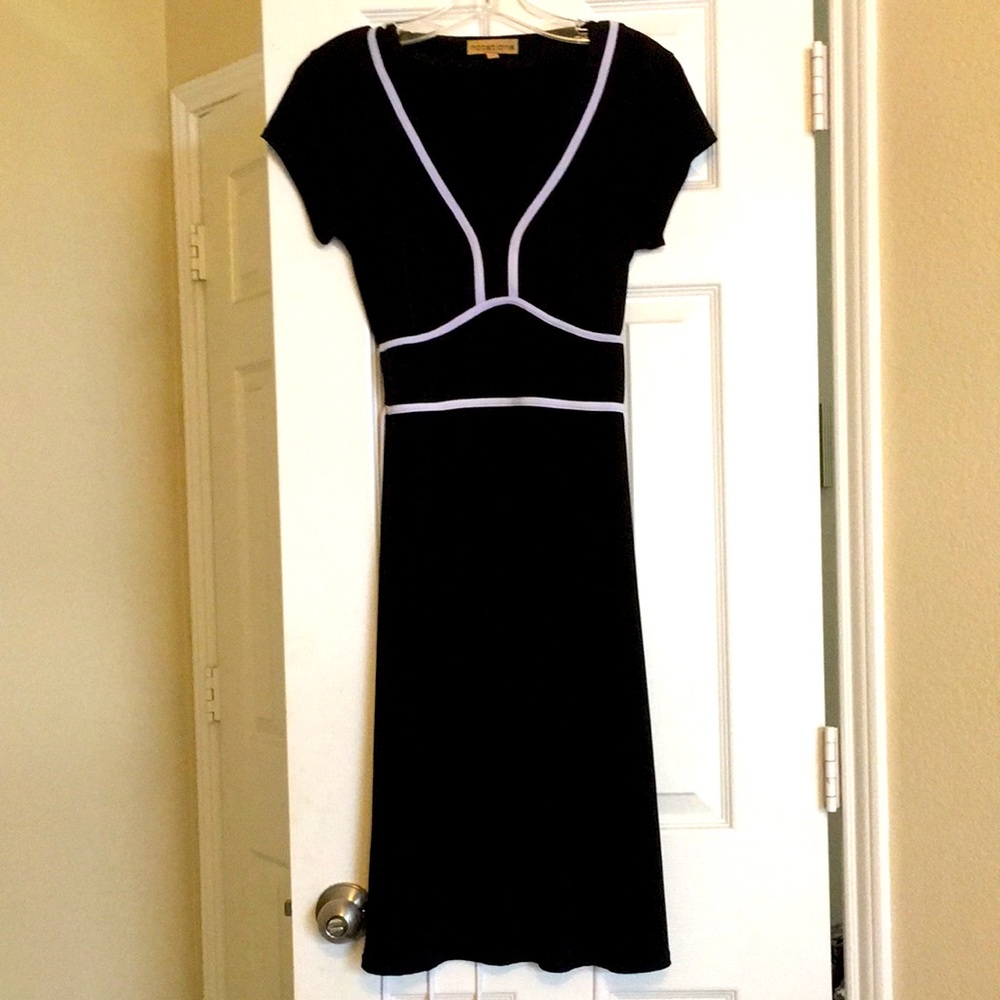 Black dress with white trim and white tie.